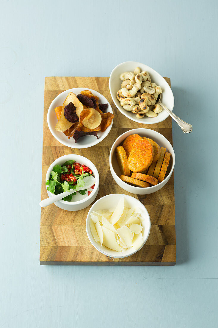 Toppings for salads - vegetable chips, cashew nuts, bread chips, parmesan