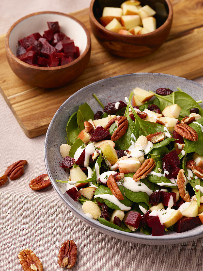 Vegan beetroot salad with apple, pecans and spinach