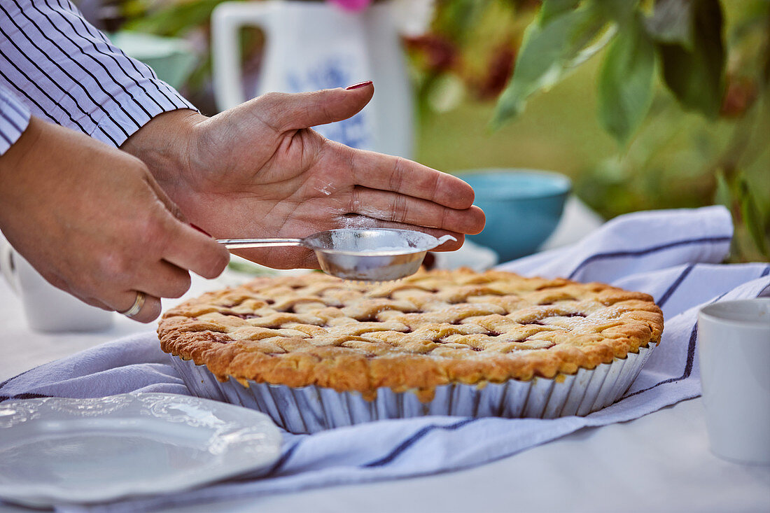 Cherry pie is sprinkled with powdered sugar