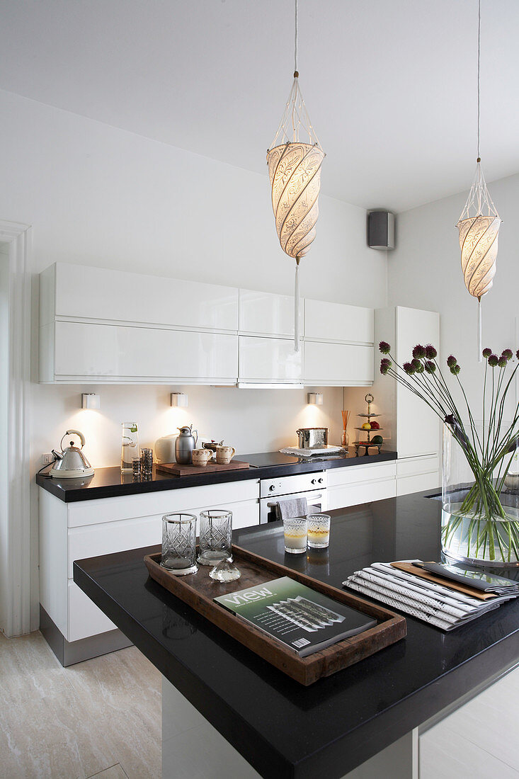 White kitchen counter and island counter with black stone top