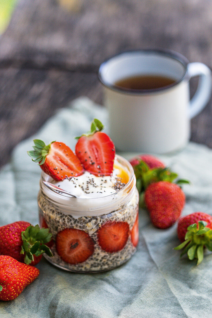 Lukewarm chia pudding in a glass with strawberries