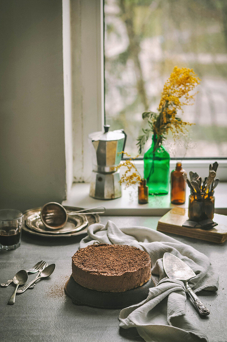 Schokoladen-Cheesecake auf Tisch am Fenster