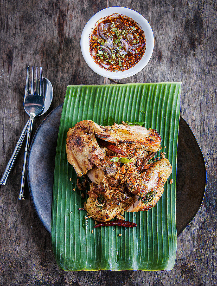 Thai Gai Yang chargriiled chicken in ginger, garlic and lemongrass served with Nahm Jim Jaew sauce