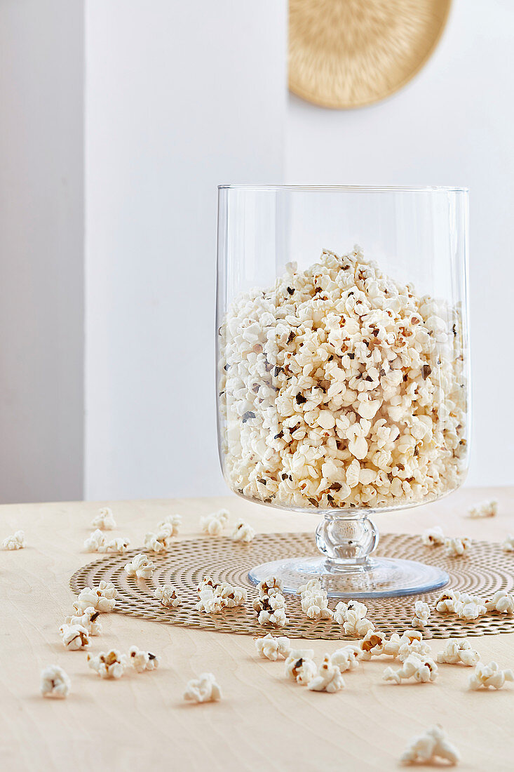 Truffle popcorns in a large glass jar inside in a white room