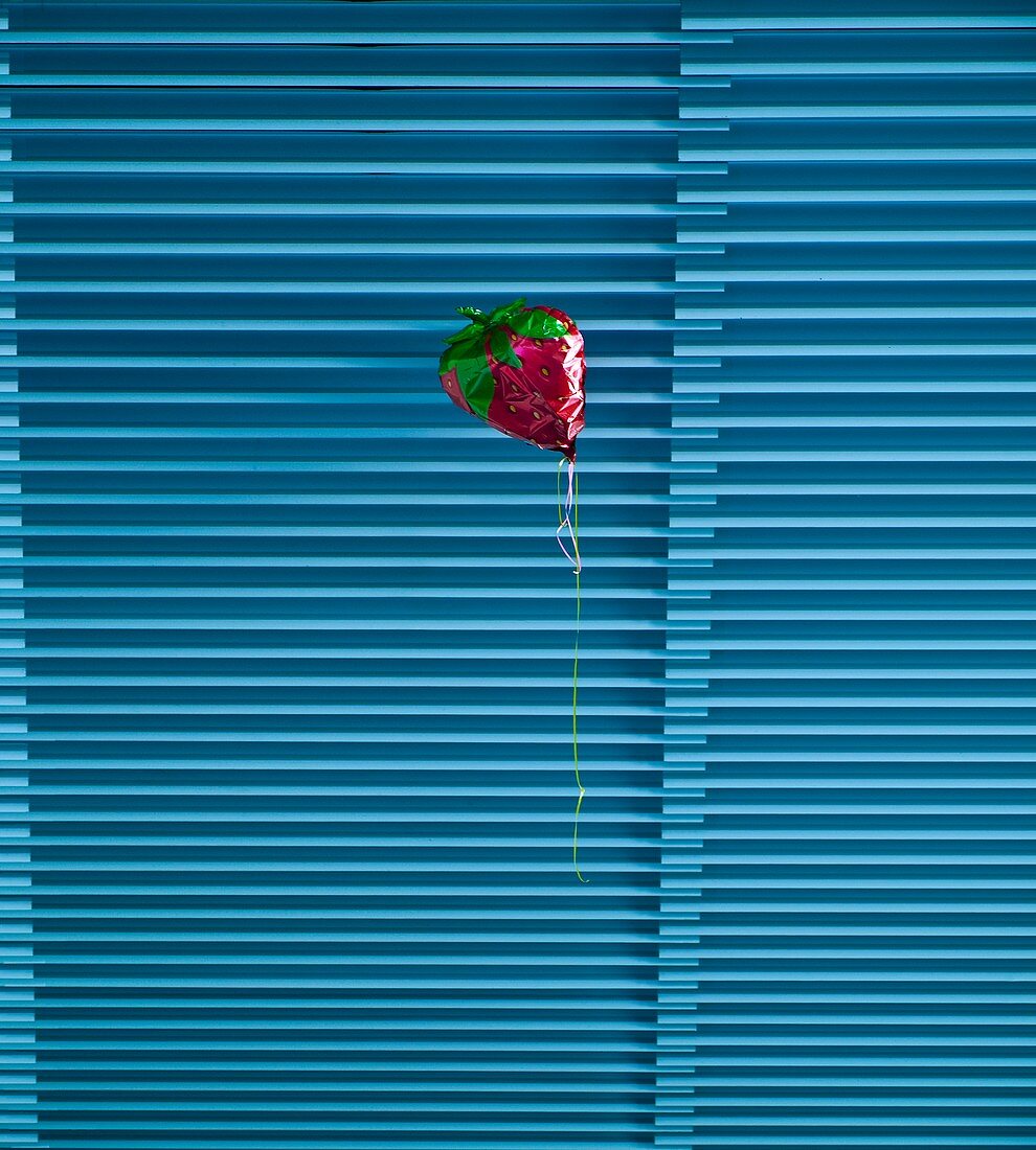 Helium balloon resting on a ceiling.