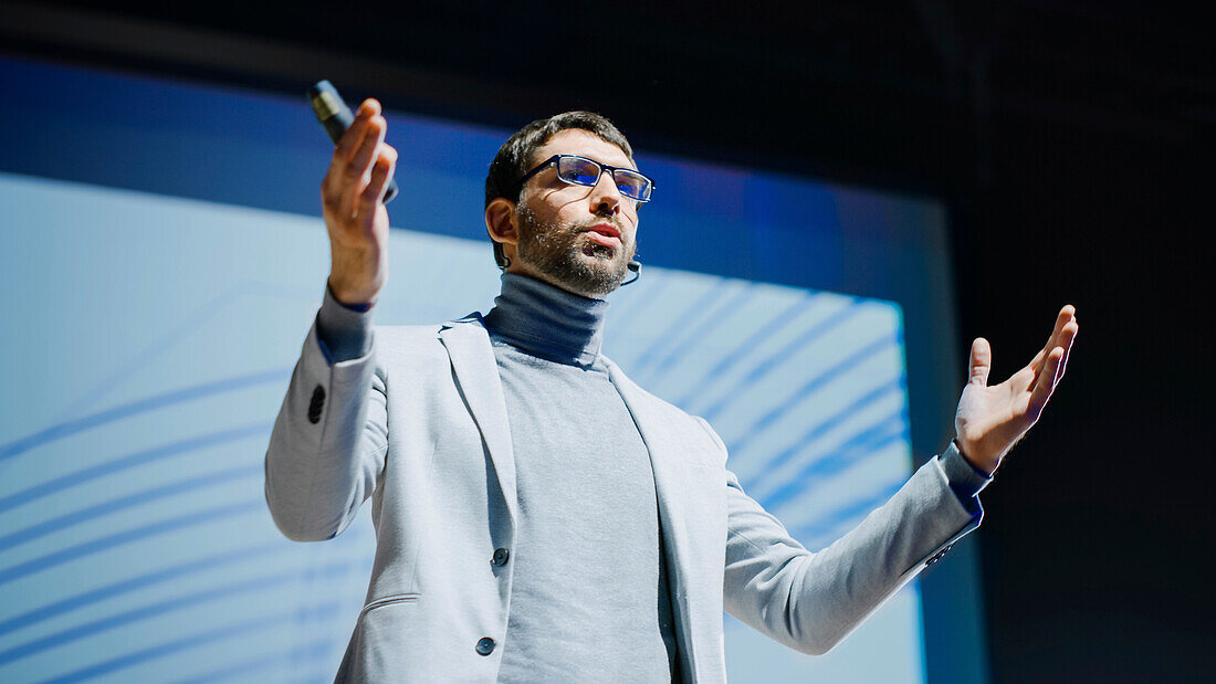 Speaker on stage at conference