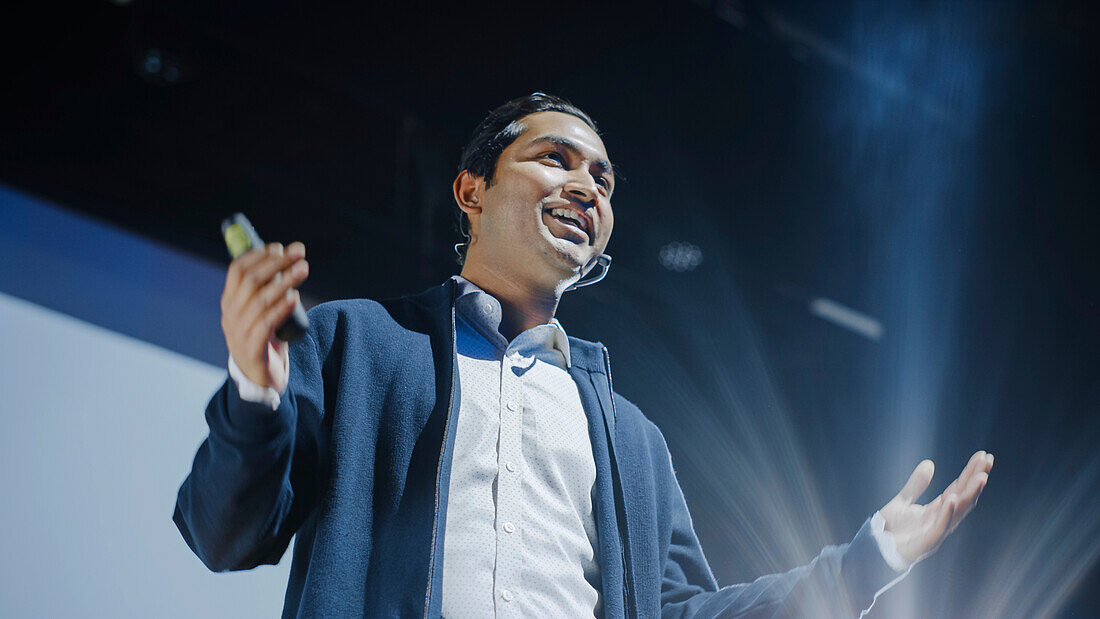 Speaker on stage at conference