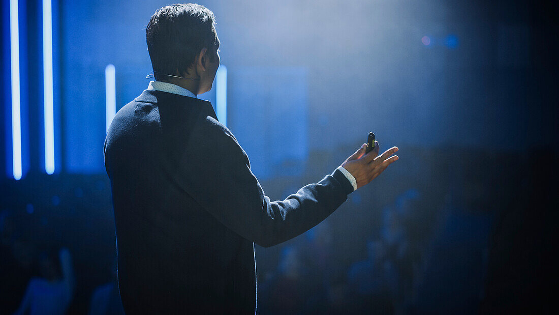 Speaker on stage at conference