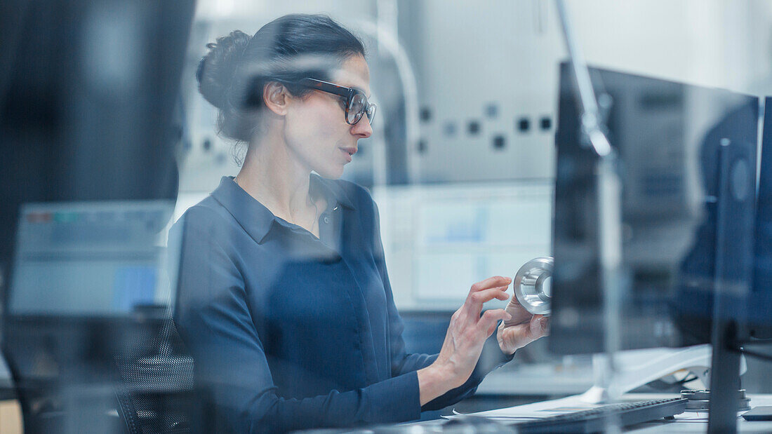 Engineer inspecting an industrial part