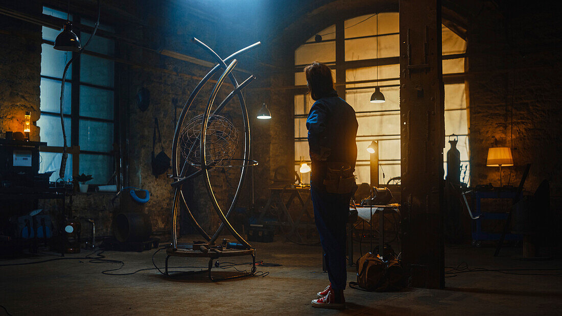 Sculptor looking at a sculpture