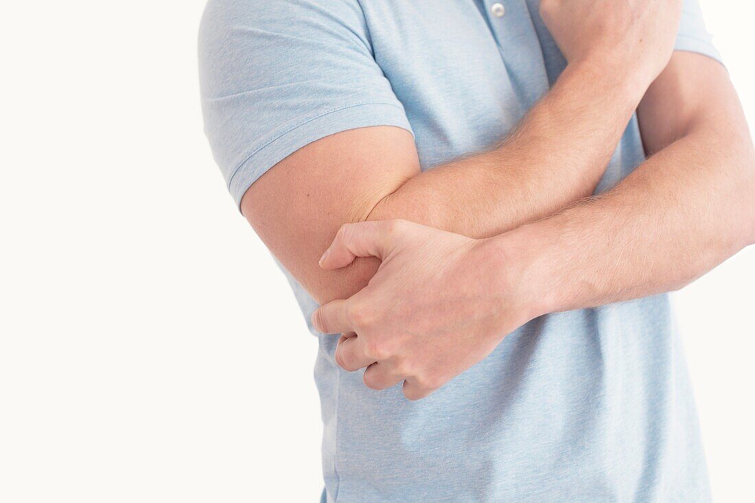 Man holding his elbow in pain