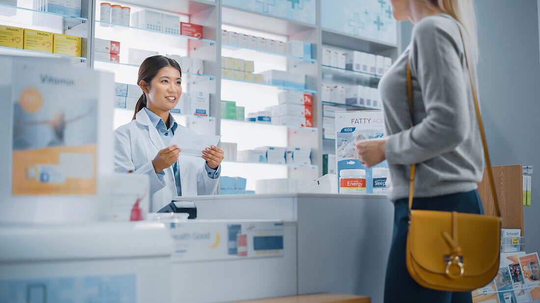 Customer giving a prescription to a pharmacist
