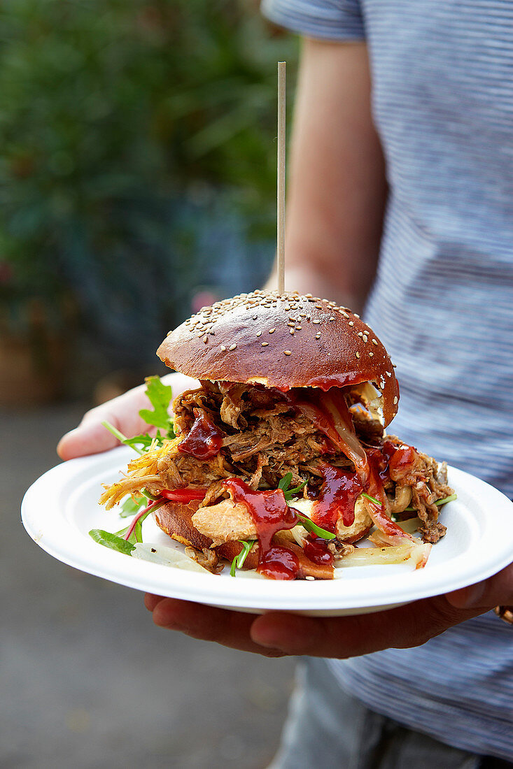 Man serving Pulled Pork Roll