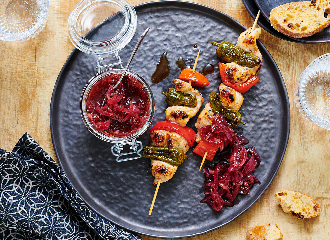 Grilled poultry and vegetable skewers with red onion chutney