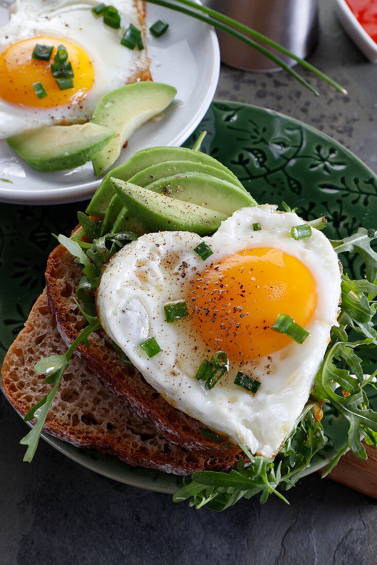 Heart-shaped fried egg on sandwich