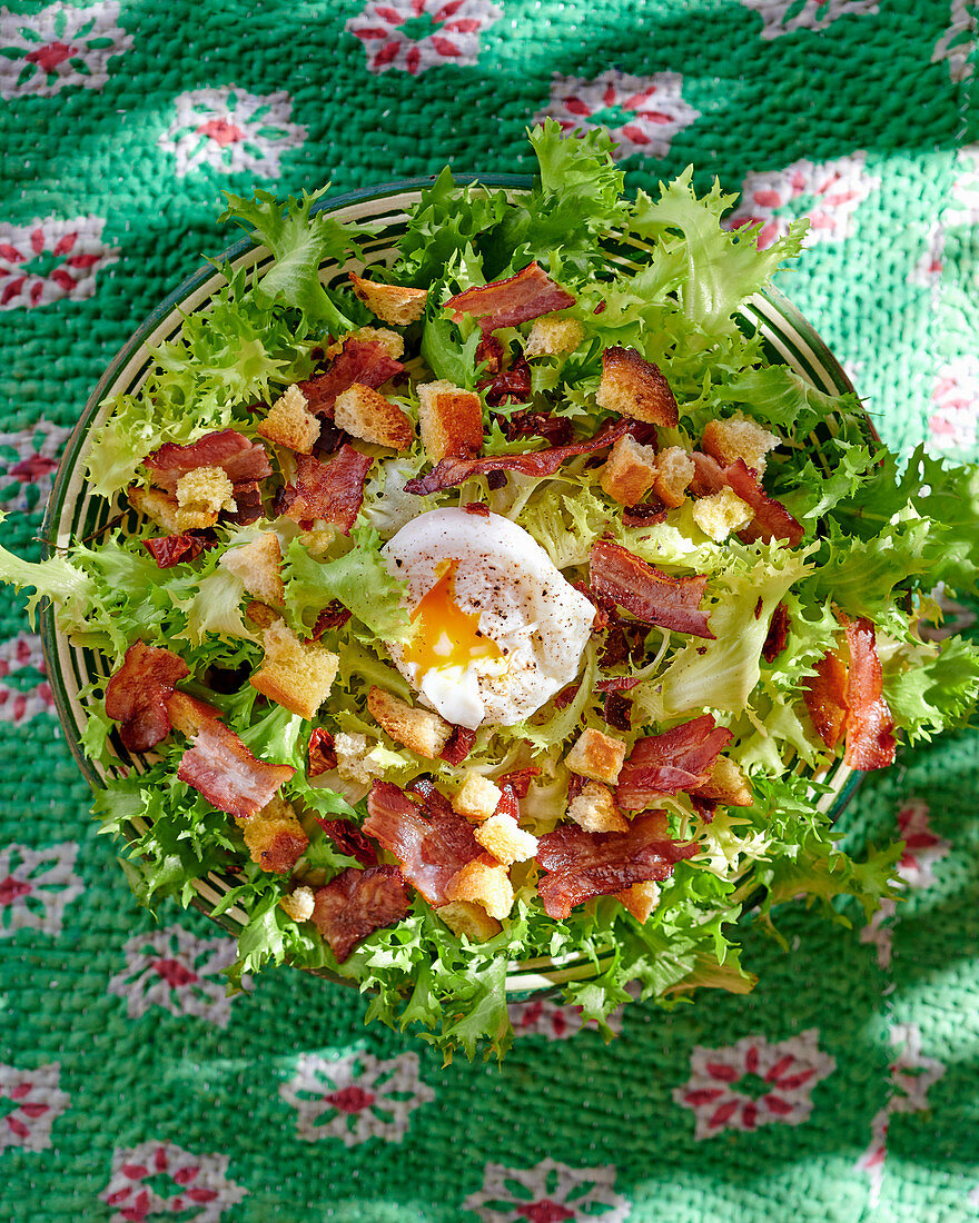 Frisée salad with bacon, croutons and a poached egg
