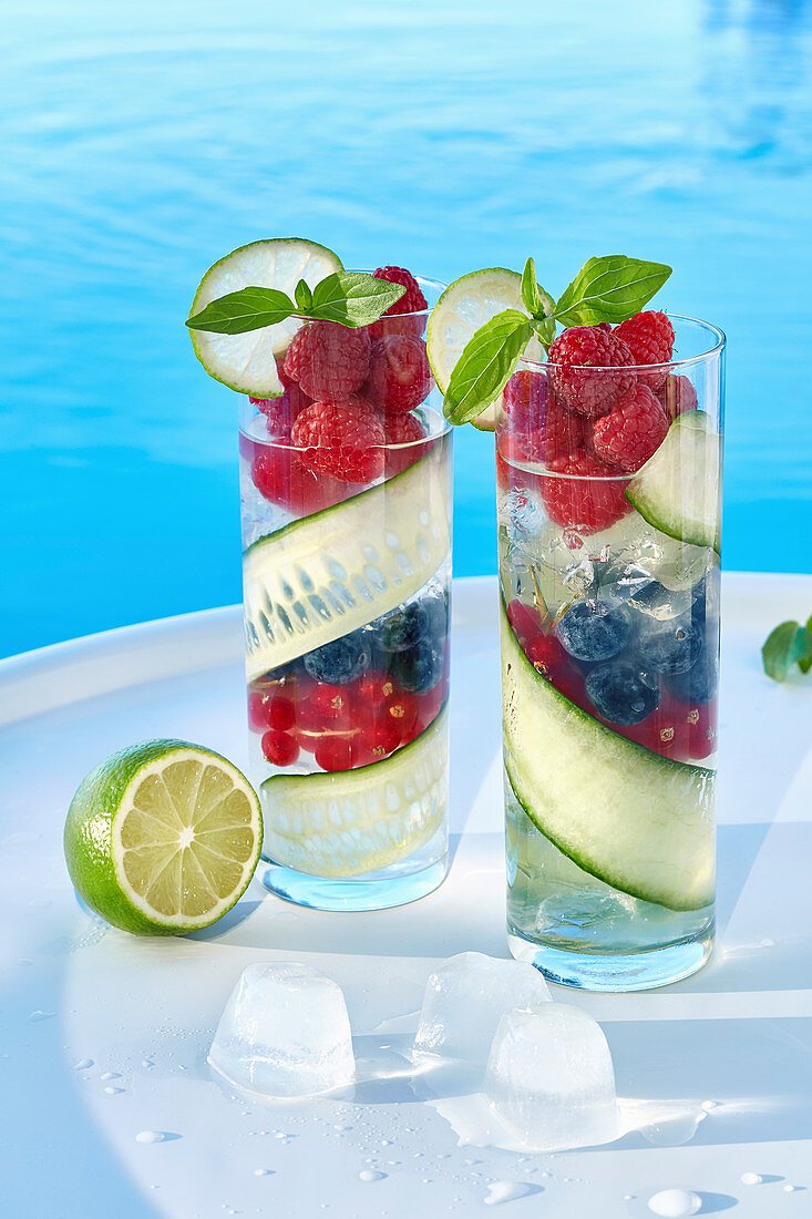 Refreshing summer cocktails with berries and cucumber