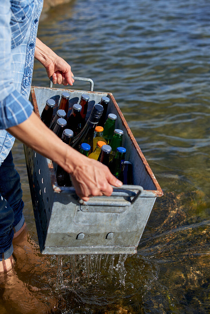 Person holding crate with drinks