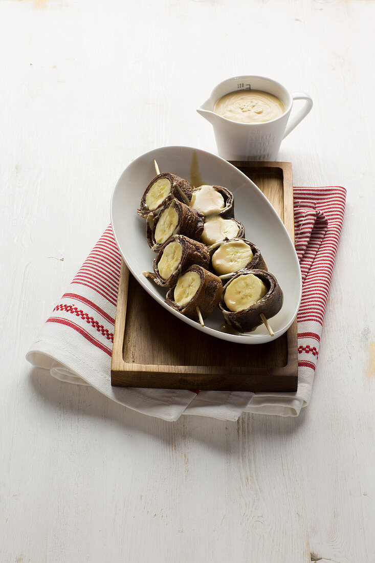 Chocolate crepe skewers with bananas and caramel sauce