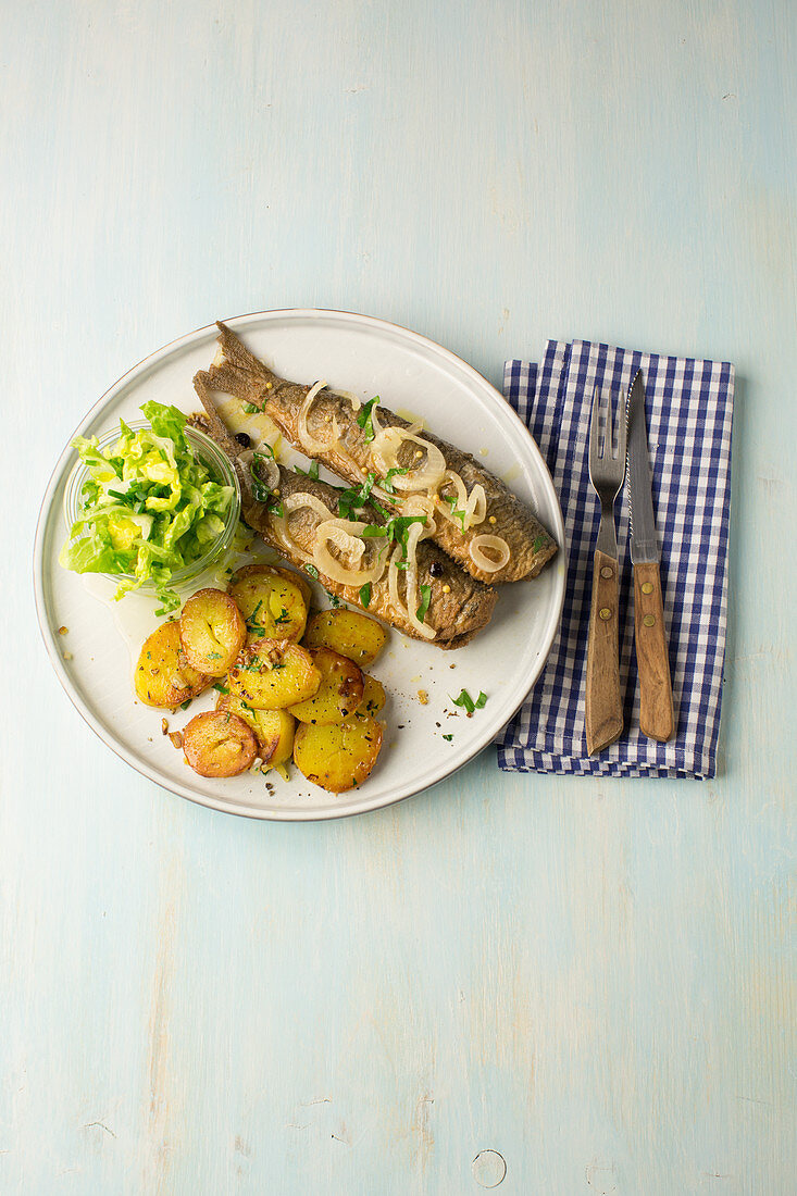 Fried herring in vinegar and onions with fried potatoes