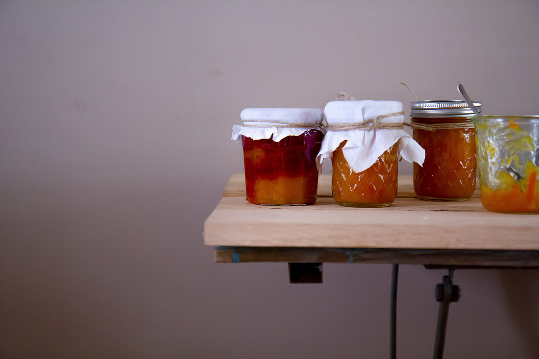 Orange jam and orange-strawberry jam in glasses on a table