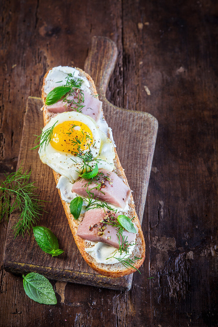 Sandwich with fried egg and smoked fish