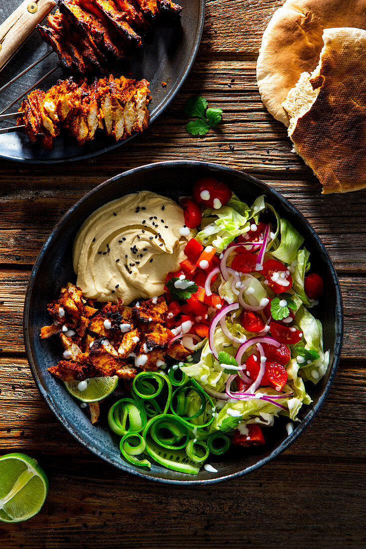 Vegetarian kebab with vegetable salad and hummus