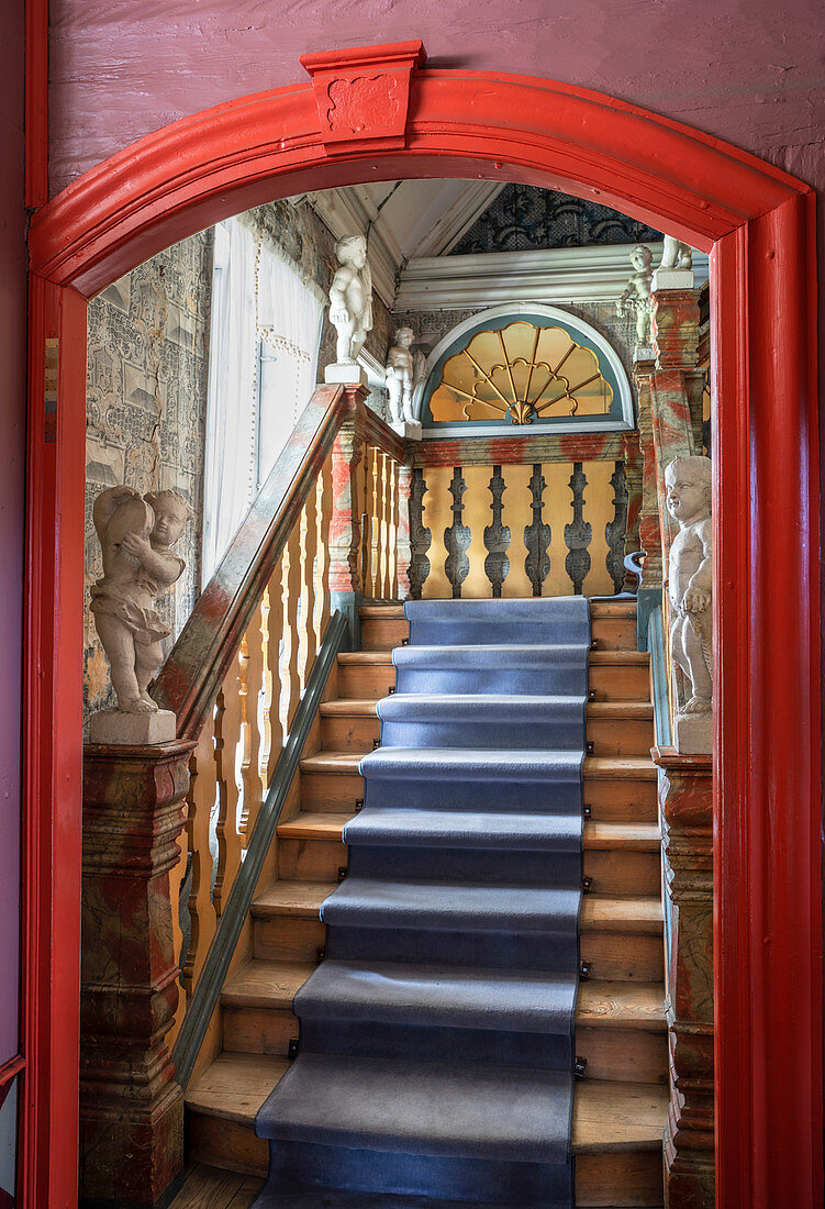 A view of wooden stairs with a stair runner