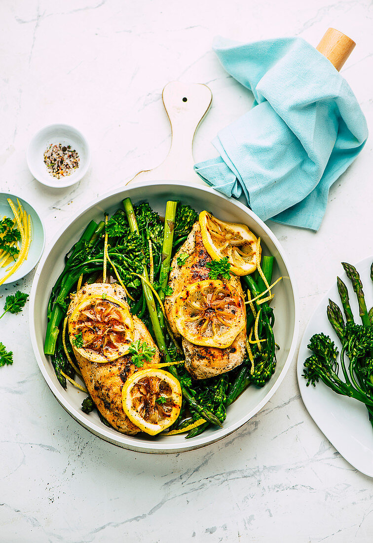 Baked lemon chicken with green asparagus and broccolini