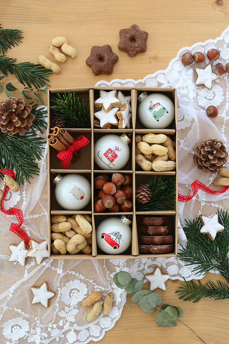 Nuts, biscuits and Christmas baubles in a seedling tray