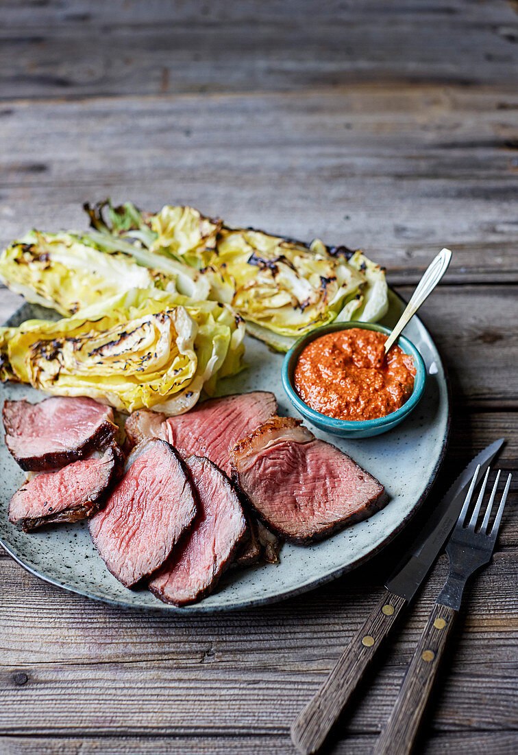 Grilled beef sirloin with charred hispi cabbage and romesco