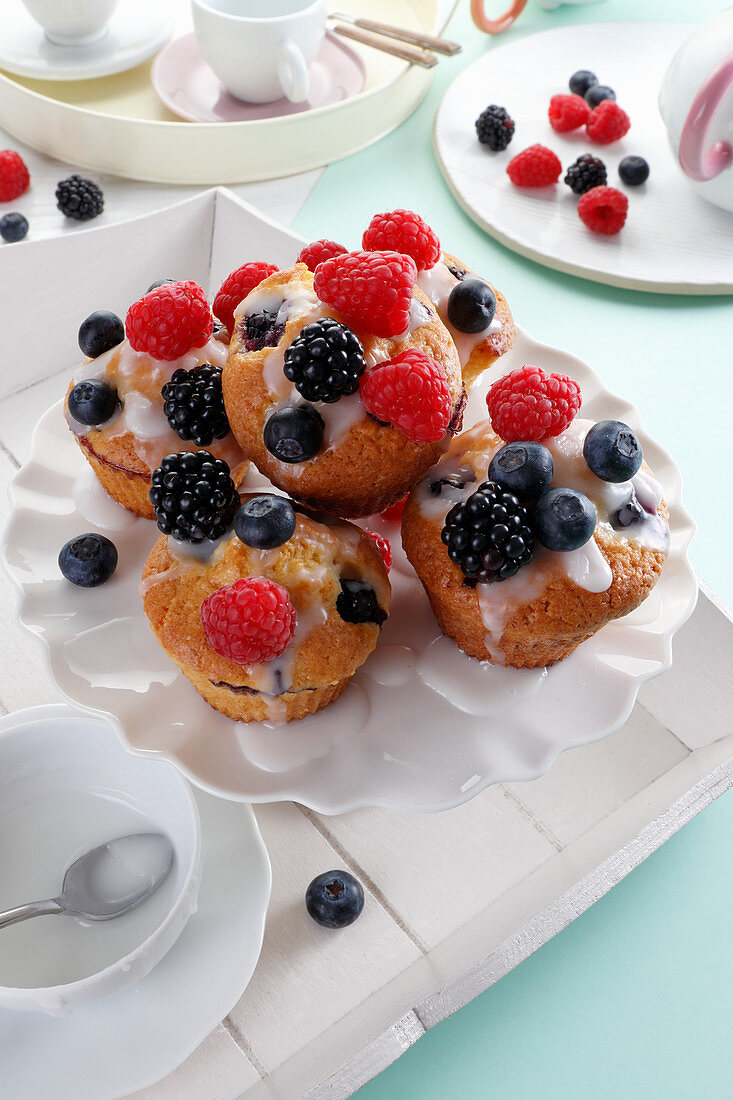 Muffins with icing and berries