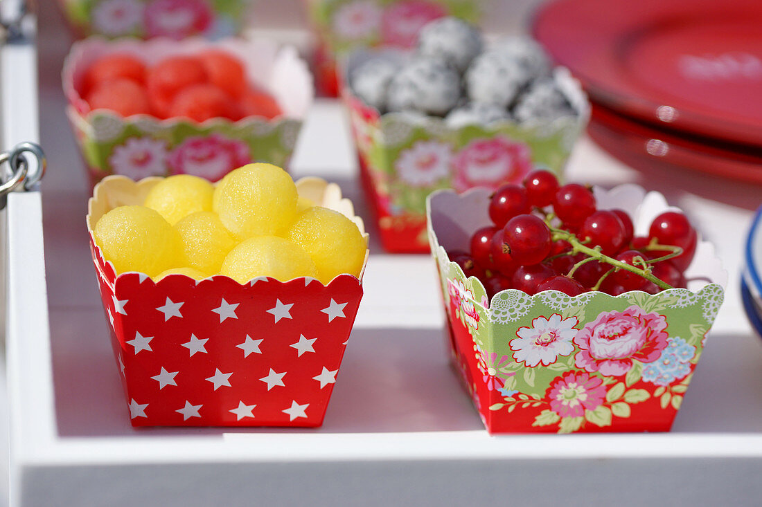 Fruit in colourful cardboard bowls