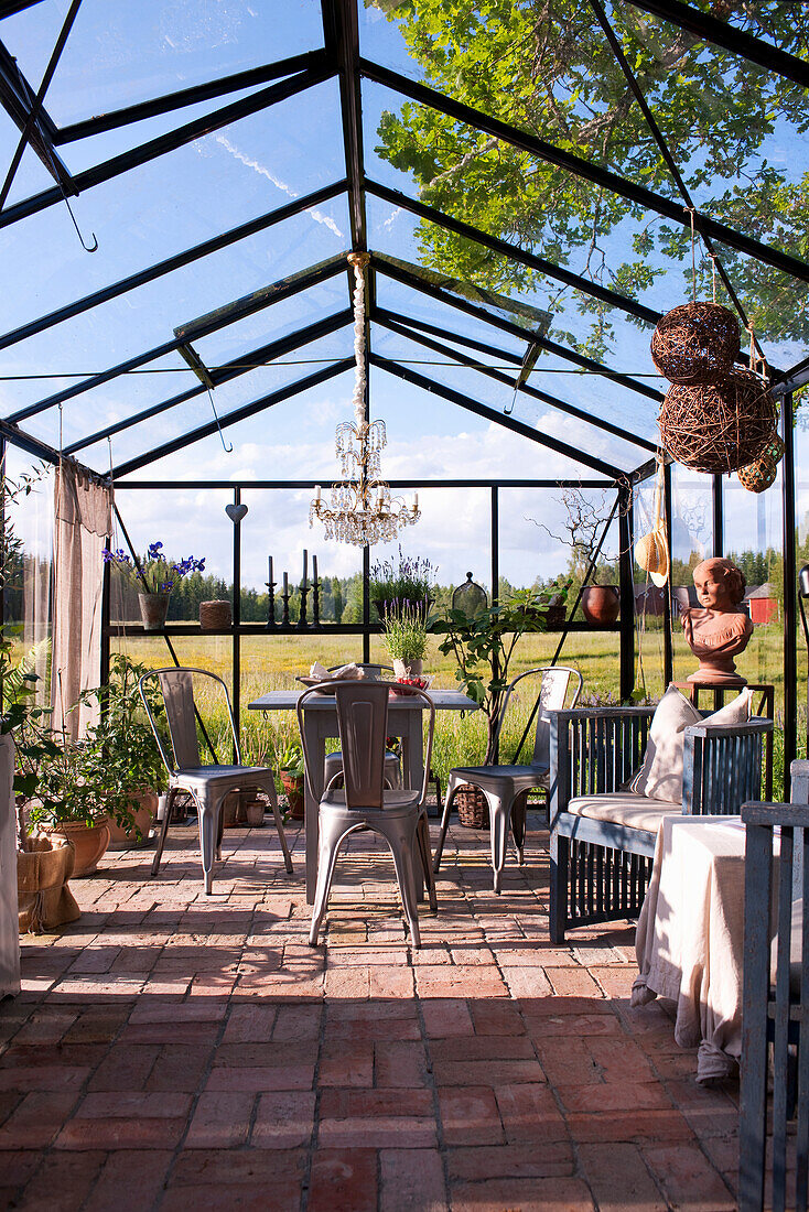 Tables and chairs in the greenhouse with terracotta floor