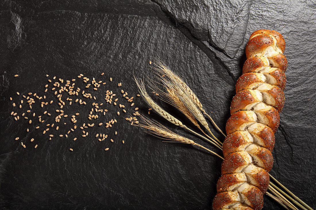 Braid next to cereal grains and wheat ears