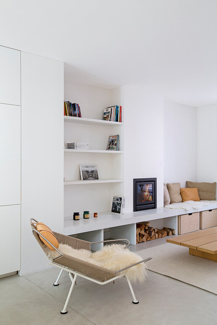 White shelves, classic recliner and bench in white living room