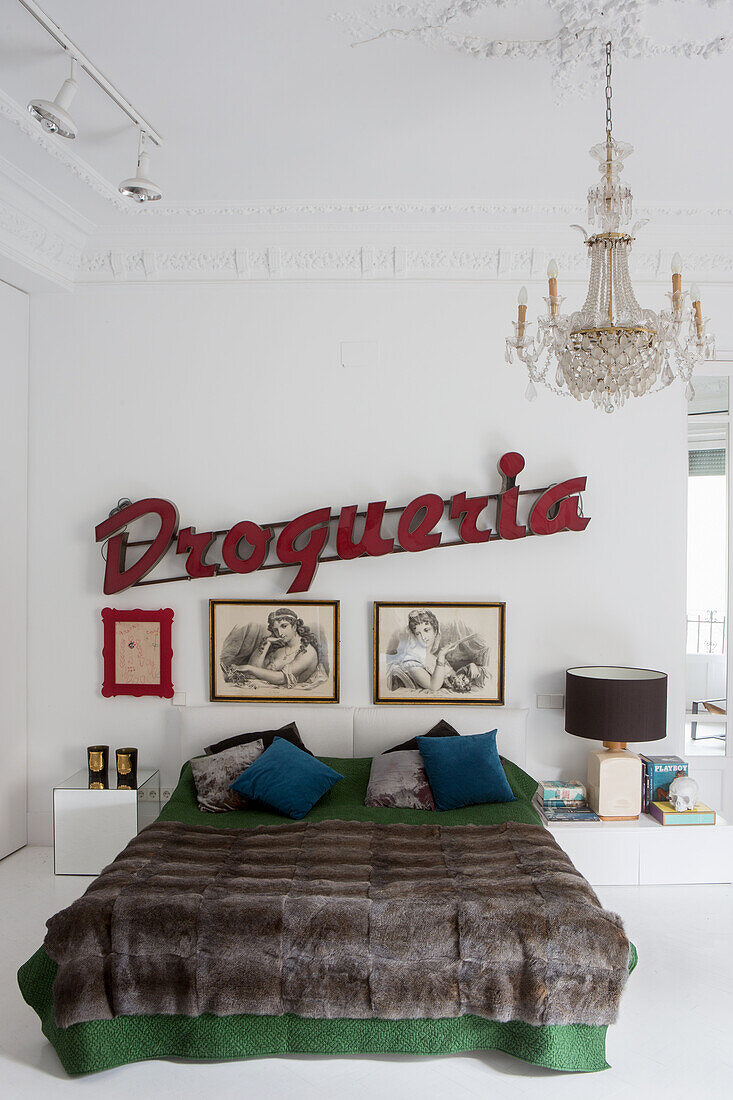 Queen bed, above artwork and vintage sign on the white wall