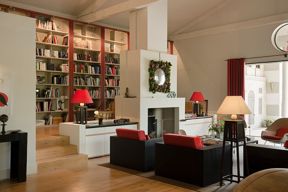 Open-plan interior with lounge and library in converted warehouse