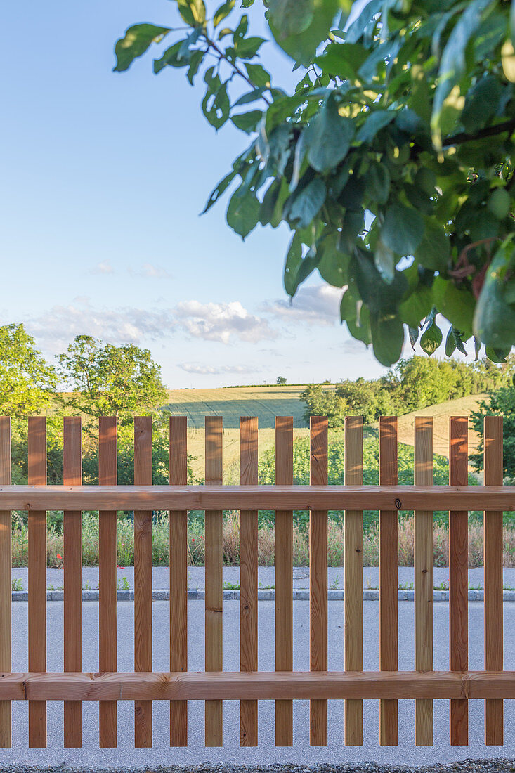 A view into the distance over a wooden fence