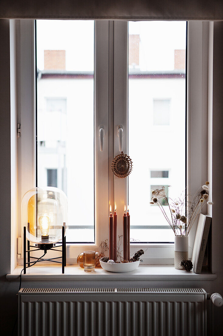 Bowl with candles on windowsill