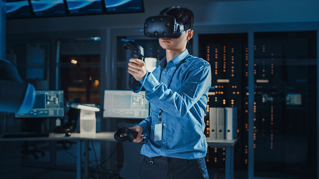 Engineer using augmented reality headset and joysticks