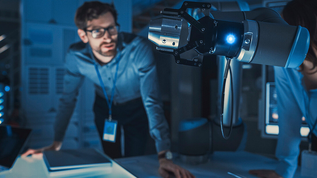 Robotic arm picking and moving a metal object