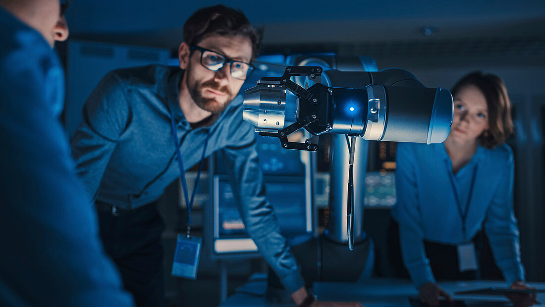 Robotic arm picking and moving a metal object