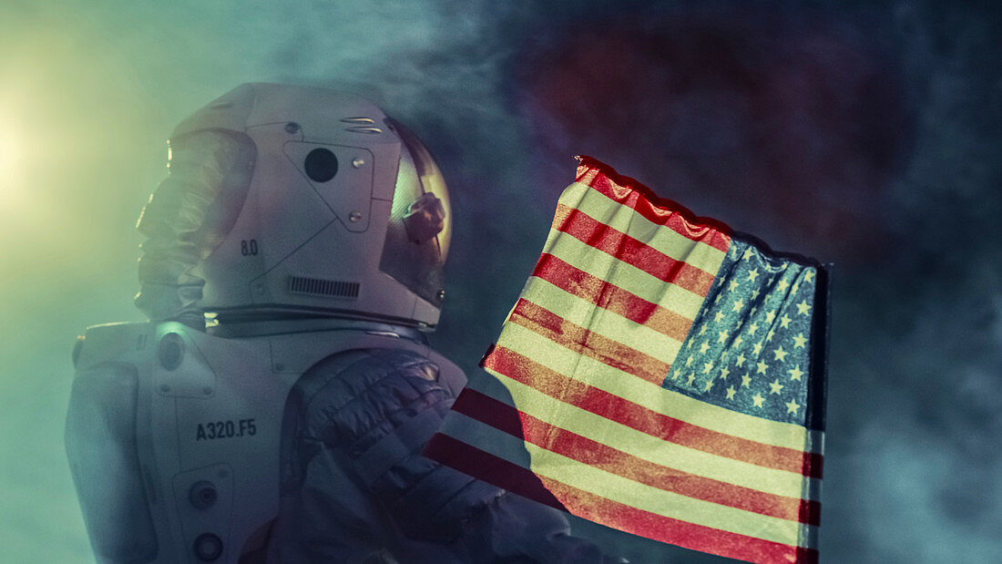 Astronaut walking with a US flag