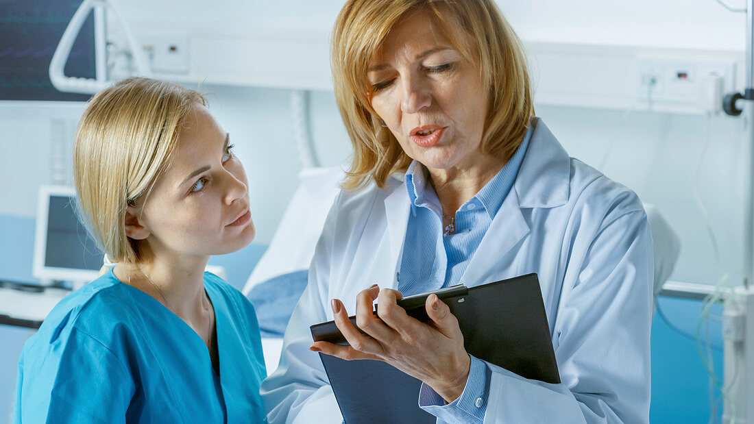 Doctor and young nurse discussing a patient's chart