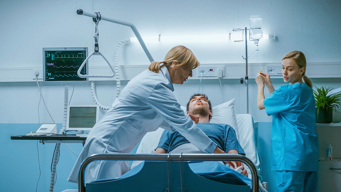 Hospital doctor and nurse trying to resuscitate a patient