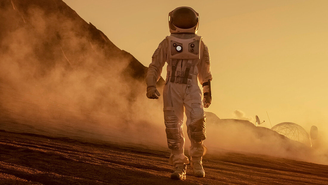Astronaut walking on the surface of alien planet