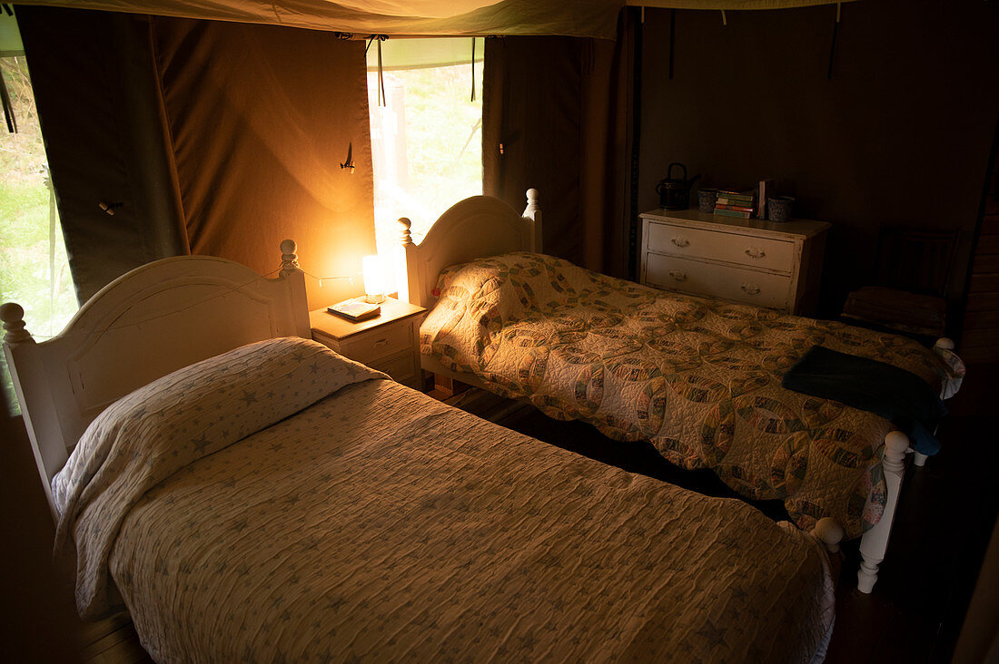 Quilts on beds in yurt cabin
