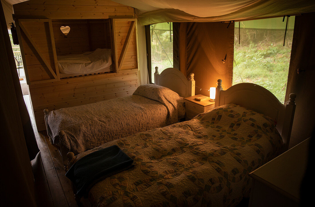 Beds with quilts in yurt cabin