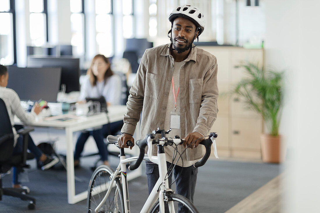 Man walking with his bicycle in an office